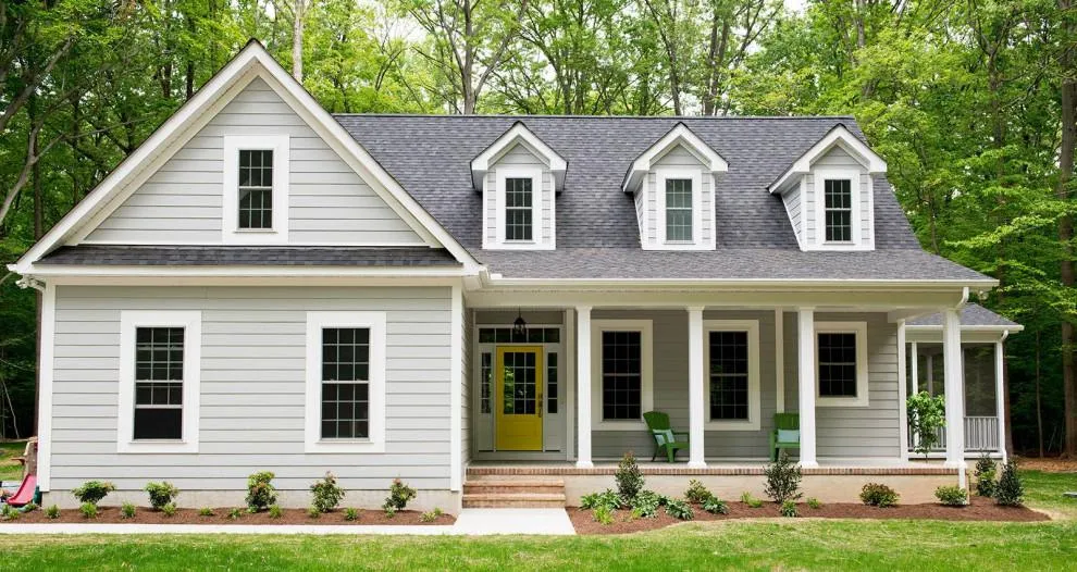 Cape Cod style home in Alpharetta with new white HardiePlank siding and yellow front door