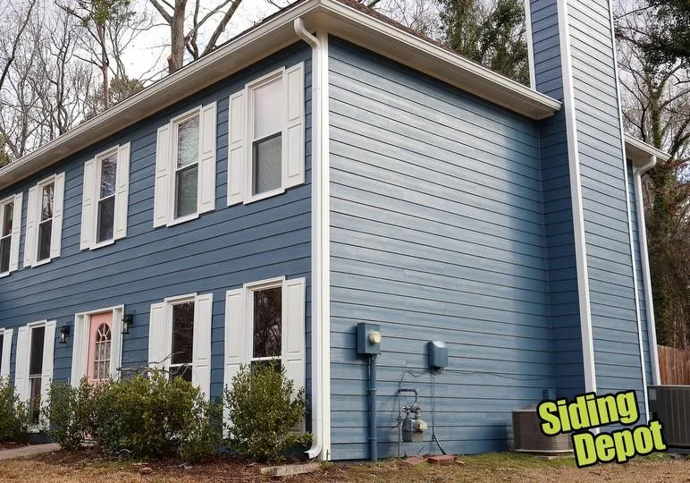 Two-story Cobb County home repainted in deep blue with crisp white trim and gutters